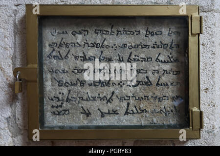 Inscription in Aramic believed to be from the 6th century, which reads: “This is the house of Mary, mother of John, called Mark. Proclaimed a church by the holy apostles under the name of Virgin Mary, mother of God, after the ascension of our Lord Jesus Christ into heaven. Renewed after the destruction of Jerusalem by Titus in the year AD 73.” inside San Marcos or Saint Mark Syrian Orthodox church at the center of the Syriac Orthodox community where prayers are conducted in Aramic language located in the Armenian Quarter old city east Jerusalem Israel Stock Photo