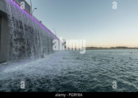 The Dubai Water Canal waterfall, where the canal meets Sheikh Zayed Road, during the day, Dubai, UAE Stock Photo