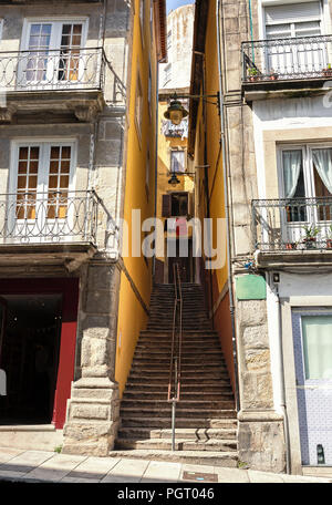 A narrow passage with a stairs between the houses in the old town of Porto (Ribeira district), Portugal. Stock Photo