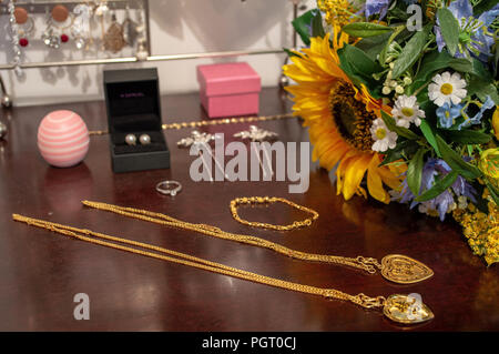 A bride's jewelry and flower bouquet before her wedding Stock Photo