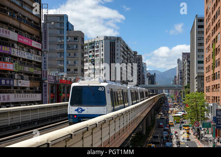 A train on the Taipei lightrail metro network leaves the Zhongxiao-Fuxing Station. Stock Photo