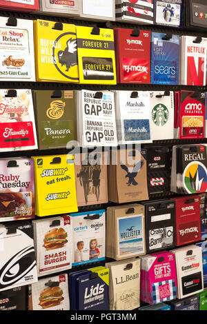 Various gift cards on display on a store rack. Stock Photo