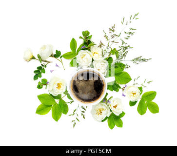 Decorative composition in retro style consisting of black coffee in a white porcelain cup and white wild rose flowers with green leaves isolated on wh Stock Photo