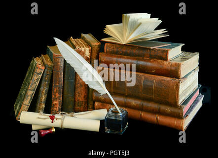 Still life with a letter, a pen and old books isolated on a black background Stock Photo