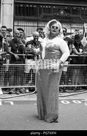 Drag queen poses with a drink in her hand at the Pride Parade Stock Photo