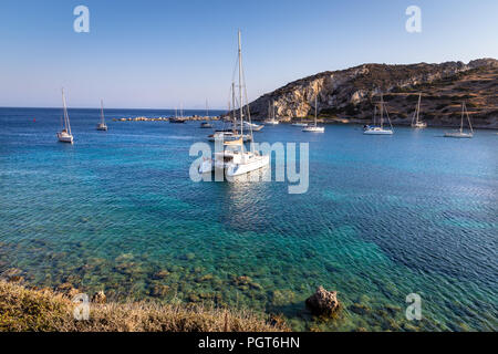 White catamaran docked in ancient bay of Knidos against blue sky. Datca peninsula, Mugla, Turkey. Stock Photo