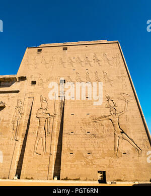 Egyptian carved figure hieroglyphs on entrance pylon of Temple of Horus, Edfu, Egypt, Africa Stock Photo