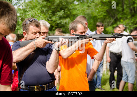 KOMSOMOLSK-ON-AMUR, RUSSIA, AUGUST 1, 2015. Public open Railroader's day.The shooting competition for men in the amateur category. men shoot from pneu Stock Photo