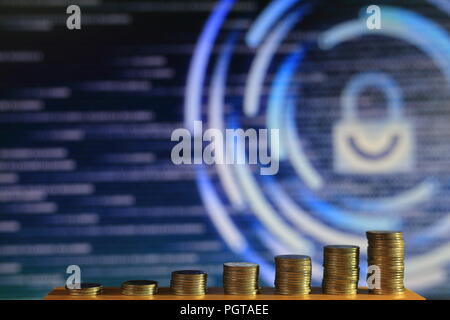 secured internet business. big coin piles in front of blue binary code computer screen. rich through savings account online. Stock Photo