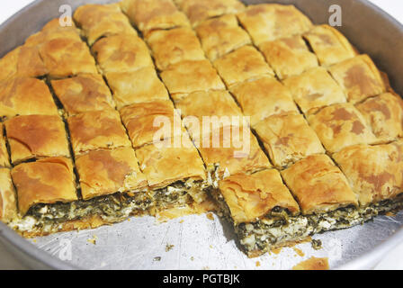 traditional greek spanakopita - spinach pie with the greek cheese feta inside a big pan Stock Photo