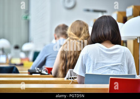 Students reading in a public library. Stock Photo
