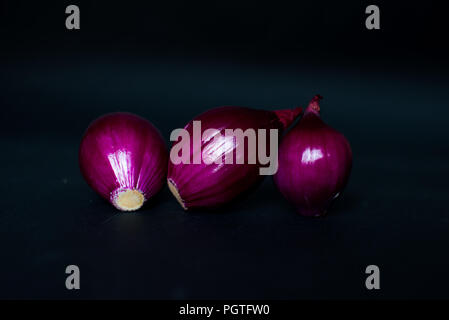 Red onions isolated on the black background. Stock Photo