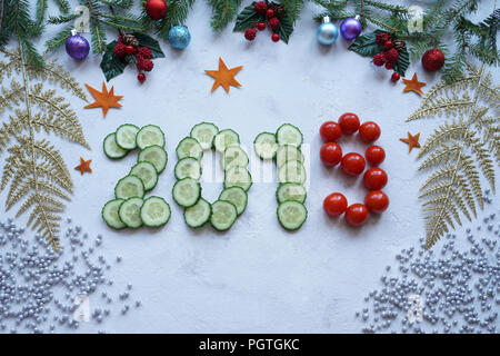 New Year's collage, healthy lifestyle, figures from cucumber and cherry tomatoes Stock Photo