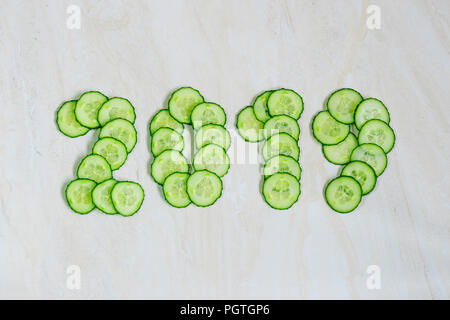 New Year's collage, healthy way of life, figures from cucumber Stock Photo