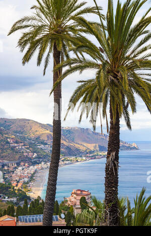 Beautiful scenery with Mediterranean sea, beaches and palm trees seen from Taormina, Sicily, Italy Stock Photo