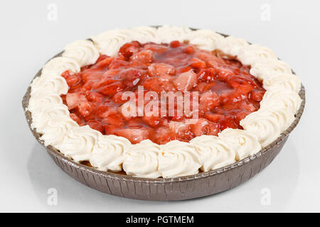 Cheesecake with berry sauce decorated with strawberry on a plate. Sweet dessert in the restaurant. Morning light Stock Photo