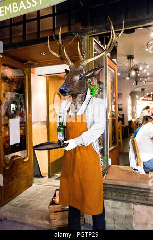 Waiter statue with a deer head holding a tray outside Ardbeg Embassy Restaurant, Gamla Stan (Old Town), Stockholm, Sweden Stock Photo