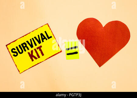 Handwriting text writing Survival Kit. Concept meaning Emergency Equipment Collection of items to help someone Yellow piece paper reminder equal sign  Stock Photo