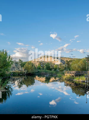 A pond reflects the surrounding landscape in Kelowna British Columbia near Knox mountain. Stock Photo