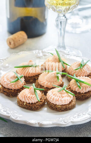 Delicious mousse of Smoked Salmon, Cream Cheese and chives on Rye Bread Slices. Selective focus Stock Photo