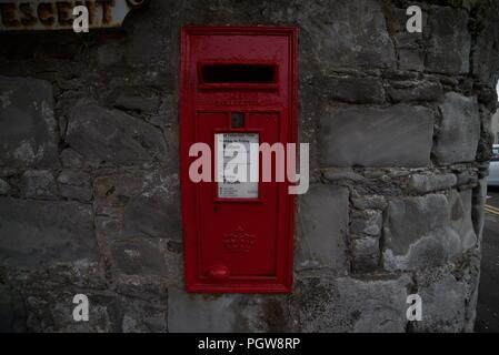 Red Post Box on a wall on a British Street Stock Photo