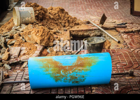 Underground PVC pipe of the water supply is broken and being repaired by the plumber. Stock Photo