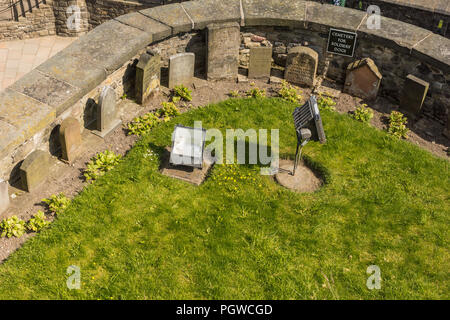 Edinburgh, Scotland, UK - June 14, 2012: Military dog cemetery with brown tomb stones and green lawn at the Castle. Stock Photo