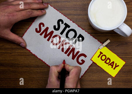 Conceptual hand writing showing Stop Smoking. Business photo text Discontinuing or stopping the use of tobacco addiction Man holding marker notebook r Stock Photo