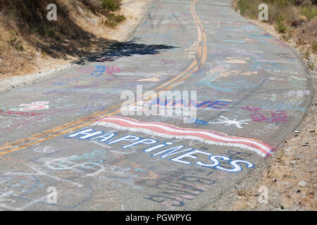 Graffiti on a road surface (graffiti on roadway) - California USA Stock Photo