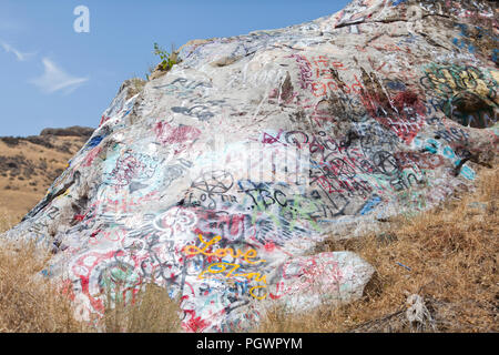 Graffiti on a boulder (graffiti in nature) - California USA Stock Photo