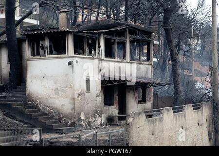 Twin wildfires raging through popular seaside areas near the Greek capital have torched homes, cars and forests and killed at least 49 people, authori Stock Photo