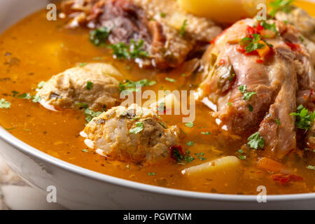 'Ciorba de Perisoare' - Romanian traditional soup with meatballs and chicken meat - close up view Stock Photo