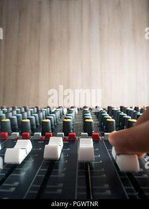 Producing music in studio on audio mixer close up Stock Photo