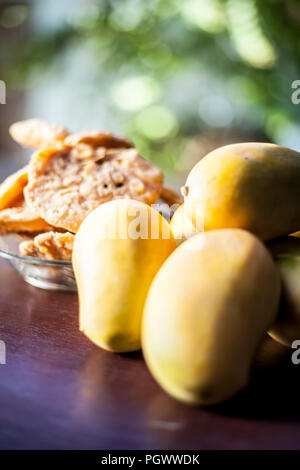 Popular Indian Asian sweet dessert dish eaten at the time of lunch ‘Aam Ras’ juice of Kesar kair with added raw milk and blend together eaten with pur Stock Photo