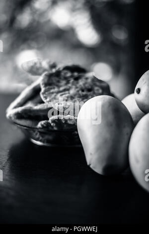 Popular Indian Asian sweet dessert dish eaten at the time of lunch ‘Aam Ras’ juice of Kesar kair with added raw milk and blend together eaten with pur Stock Photo