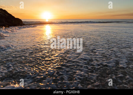 An orange sunset on a clear night over the ocean in Perth Western Australia Stock Photo