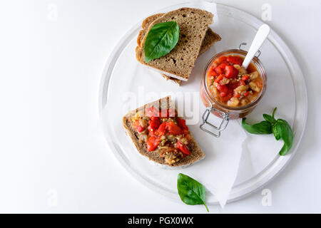 Rye bread toasts and glass jar with eggplant caviar. Vegetable appetizer or antipasti. Healthy food concept Stock Photo