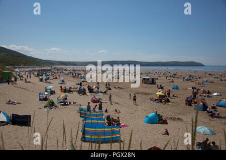 People enjoying a summers day on Woolacombe Beach, North Devon, England, blue sky and a large sandy beach with lots of people having a great day out Stock Photo