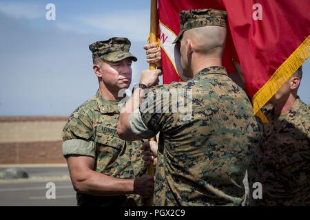 Lt. Col. Bradley Ledbetter, commanding officer, 1st Marine Support Raider Battalion, U.S. Marine Corps Forces, Special Operations Command, left, receives the guidon from Lt. Col. Richard Martin, previous commanding officer, 1st MRSB, MARSOC, during a change of command ceremony at Marine Corps Base Camp Pendleton, California, June 15, 2018. The passing of the unit guidon symbolized the transfer of responsibility, authority and accountability of the command and it’s Marines. Stock Photo