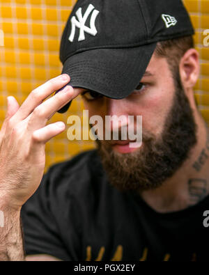 Portrait of a young hipster tattooed man with New York Yankees hat Stock Photo