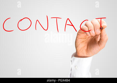 Closeup of male hand writing word Contact on virtual screen. Stock Photo