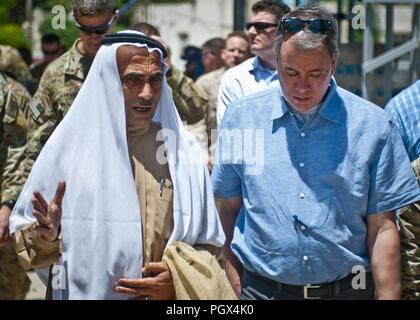 John Rood, Under Secretary of Defense for Policy, talks with a local elder while touring Manbij, Syria, June 21, 2018. Rood and key leaders from the U.S. military toured a bustling market to see how the city has been safe and thriving since ISIS was defeated by the Syrian Democratic Forces. Stock Photo