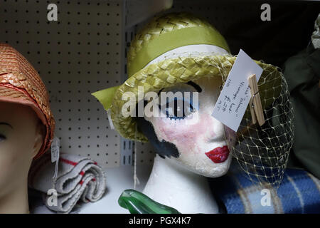 Female Mannequin Head wearing a Straw Hat and Bric-à-brac on display an English Antiques centre Stock Photo