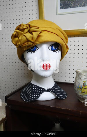 Mannequin Head wearing yellow hat on display an English Antiques centre Stock Photo