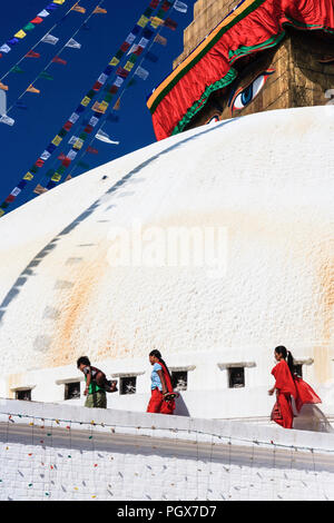 Bodhnath , Kathmandu, Bagmati, Nepal : Three women walk around the Great stupa of Bodhnath, the largest in Asia and one of the larger in the world. Stock Photo