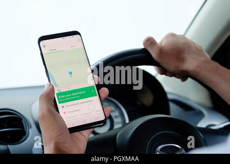 CHIANG MAI,THAILAND - August 26, 2018 : Samsung galaxy S8 Plus open grab application on man hands in car,Grab taxi Many Thailand people are attracted  Stock Photo