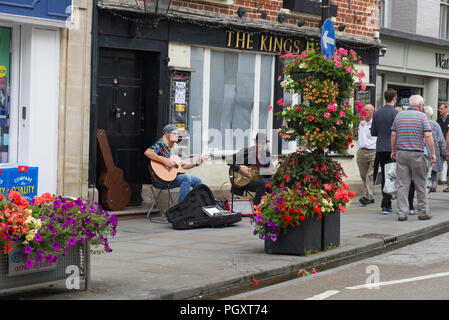 Street Musicians  performing on Wells hight street, Wells,Somerset, UK Stock Photo