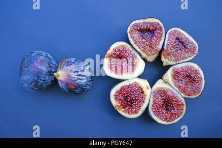 Fresh figs on dark blue background. Beautiful blue violet figs with as close up. Stock Photo