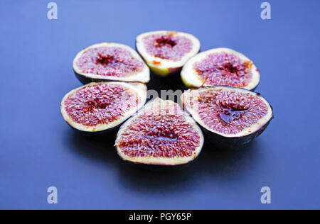 Fresh figs on dark blue background. Beautiful blue violet figs with as close up. Stock Photo