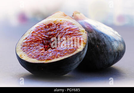 Figs whole and sliced on gray background Stock Photo